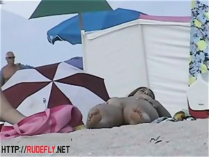 Beach cuties drape out naked below the sun
