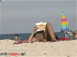 scorching babes filmed lounging on a naturist beach